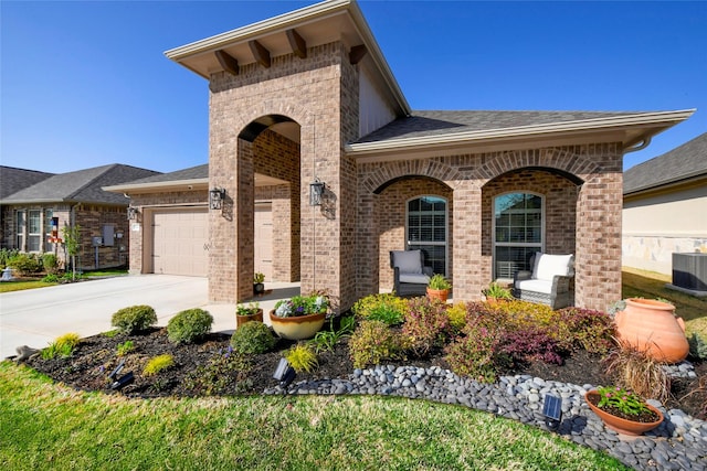 5314 Tribolo Trl, Round Rock, TX 78665 - view of front of home with driveway, brick siding, a garage, and covered porch