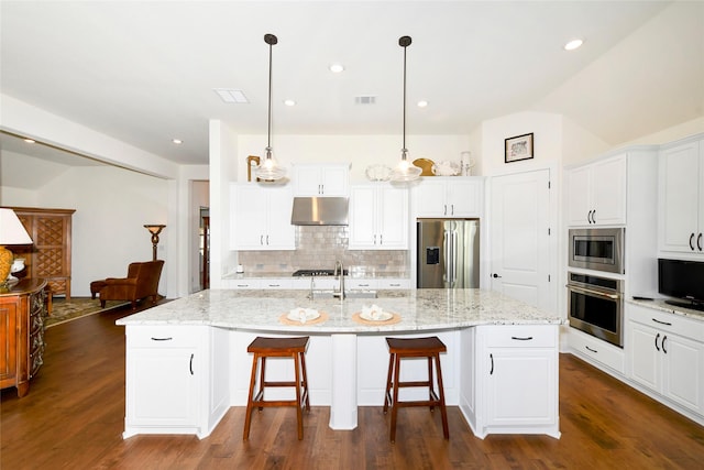 5314 Tribolo Trl, Round Rock, TX 78665 - kitchen with under cabinet range hood, dark wood finished floors, tasteful backsplash, and appliances with stainless steel finishes