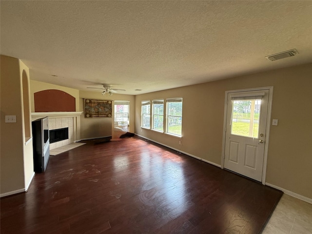 3307 Manor Tree Ln SW, Houston, TX 77068 - unfurnished living room with a textured ceiling, wood finished floors, a fireplace, and ceiling fan