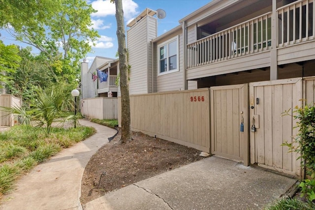 9566 Windswept Ln Unit 9566, Houston, TX 77063 - view of home's exterior featuring a gate and a balcony