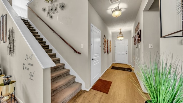 2201 Moonstone Ct, Texas City, TX 77591 - entryway featuring stairway, light wood-style flooring, and baseboards
