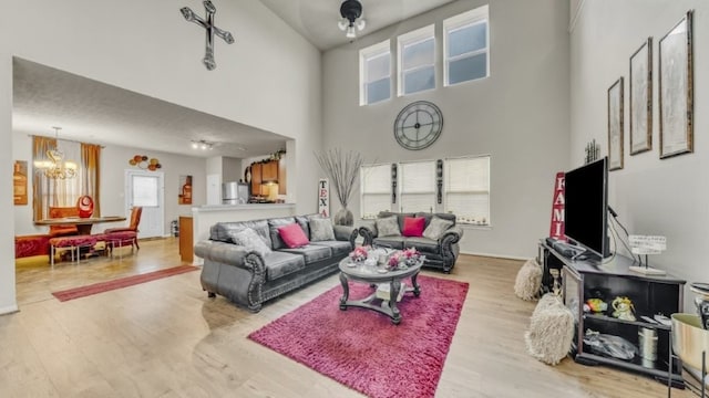 2201 Moonstone Ct, Texas City, TX 77591 - living room featuring a chandelier, wood finished floors, and a towering ceiling