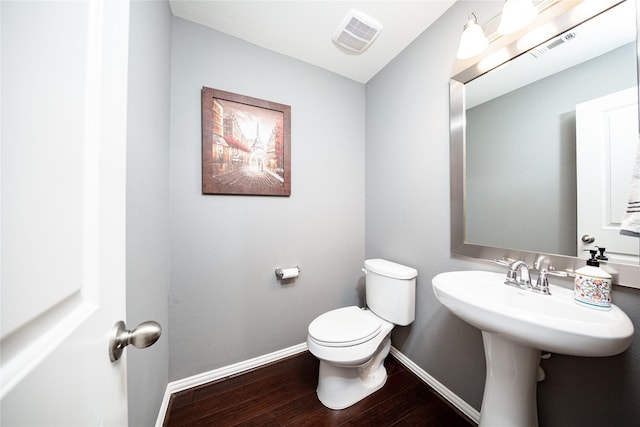 6014 Barrett Cove Ct, Richmond, TX 77407 - bathroom with baseboards, toilet, wood finished floors, and visible vents