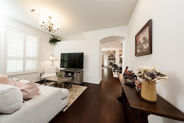 6014 Barrett Cove Ct, Richmond, TX 77407 - living area with an inviting chandelier, arched walkways, baseboards, and dark wood-style floors