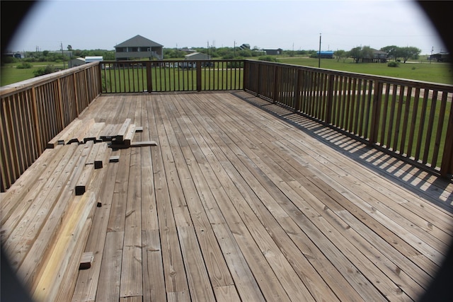 wooden deck featuring a yard