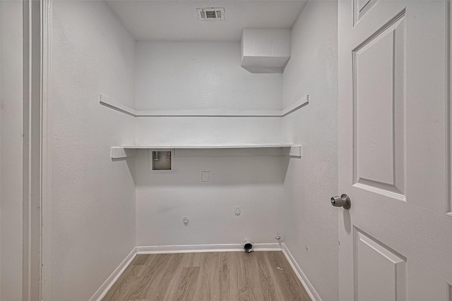 6219 Canada Dr, Pasadena, TX 77505 - washroom featuring hookup for a gas dryer, wood finished floors, laundry area, baseboards, and visible vents