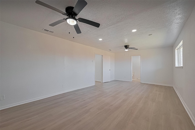 6219 Canada Dr, Pasadena, TX 77505 - empty room with a ceiling fan, light wood finished floors, a textured ceiling, baseboards, and visible vents