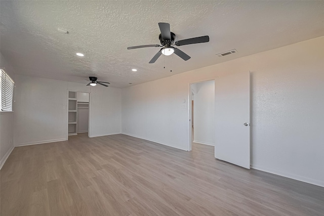 6219 Canada Dr, Pasadena, TX 77505 - interior space with a textured ceiling, visible vents, light wood-style floors, and a ceiling fan