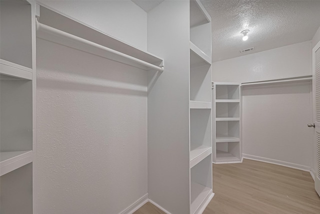 6219 Canada Dr, Pasadena, TX 77505 - walk in closet featuring visible vents and wood finished floors