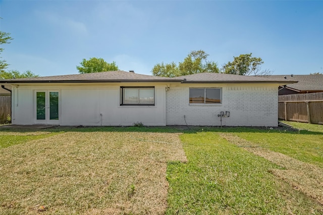 6219 Canada Dr, Pasadena, TX 77505 - rear view of property with french doors, brick siding, fence, and a lawn