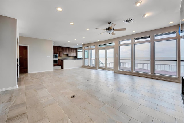 unfurnished living room featuring recessed lighting, visible vents, ceiling fan, and baseboards