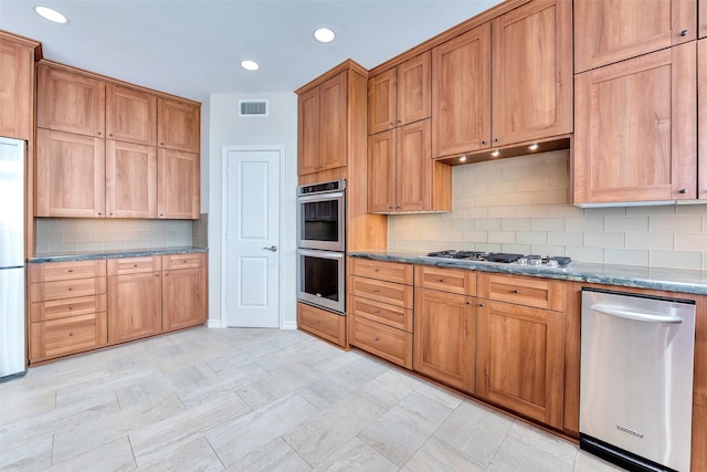 kitchen featuring tasteful backsplash, appliances with stainless steel finishes, visible vents, stone countertops, and recessed lighting