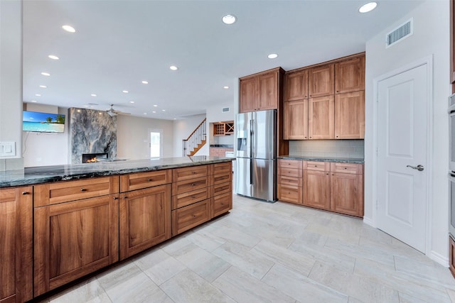 kitchen featuring recessed lighting, visible vents, backsplash, and stainless steel fridge with ice dispenser