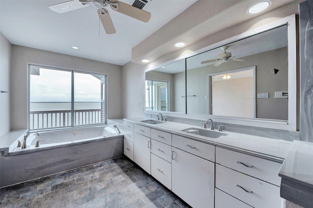 bathroom featuring recessed lighting, ceiling fan, and a sink