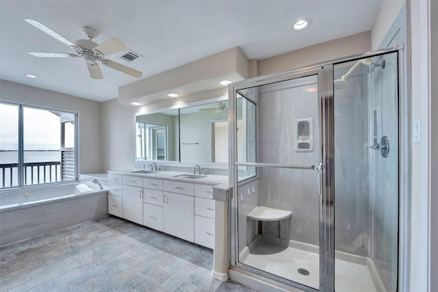 full bath featuring visible vents, a stall shower, ceiling fan, and a sink