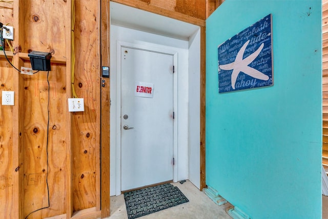 doorway featuring unfinished concrete floors