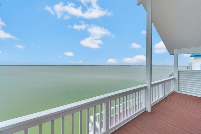 wooden terrace featuring a water view