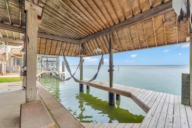 dock area with a water view and boat lift