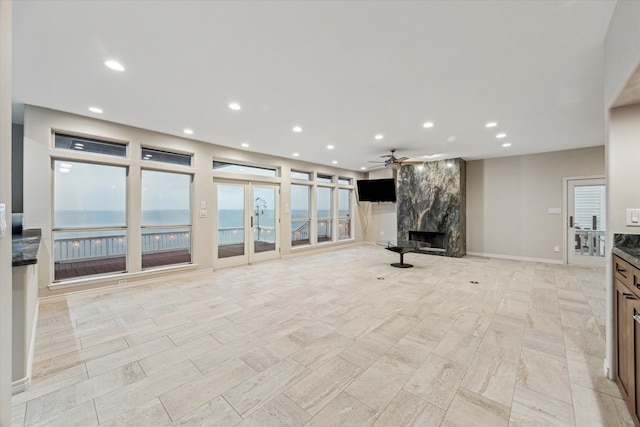 301 Isles End Rd, Tiki Island, TX 77554 - unfurnished living room featuring a premium fireplace, a ceiling fan, and recessed lighting
