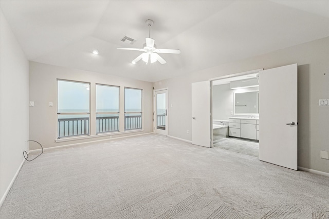 301 Isles End Rd, Tiki Island, TX 77554 - unfurnished bedroom with baseboards, light carpet, connected bathroom, and a water view