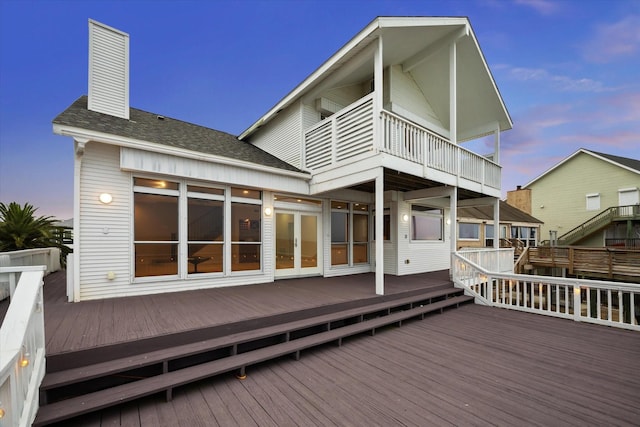 301 Isles End Rd, Tiki Island, TX 77554 - rear view of house with roof with shingles, a chimney, a deck, french doors, and a balcony