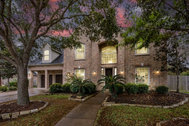 traditional-style house with brick siding and fence