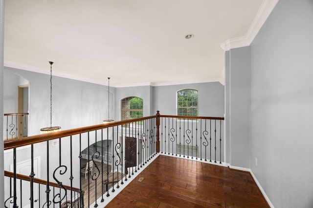 hall with baseboards, ornamental molding, and hardwood / wood-style floors