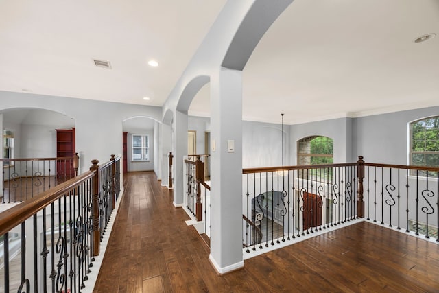 corridor featuring visible vents, baseboards, recessed lighting, hardwood / wood-style flooring, and an upstairs landing