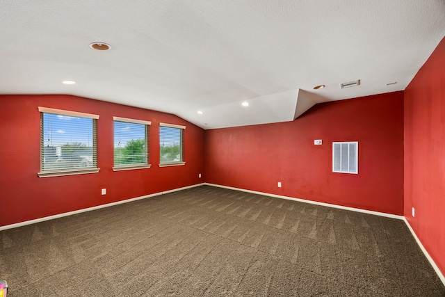 bonus room with carpet floors, visible vents, baseboards, and lofted ceiling