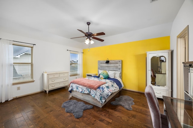 bedroom with a ceiling fan, baseboards, and wood finished floors