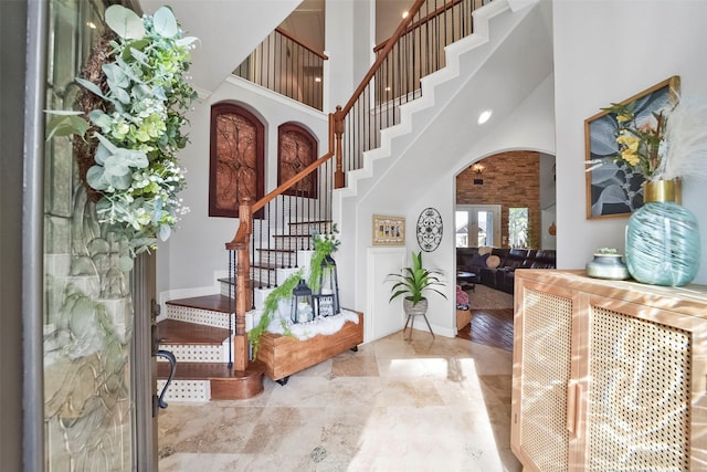 27603 Siandra Creek Ln, Spring, TX 77386 - foyer featuring baseboards, stairs, arched walkways, and a towering ceiling