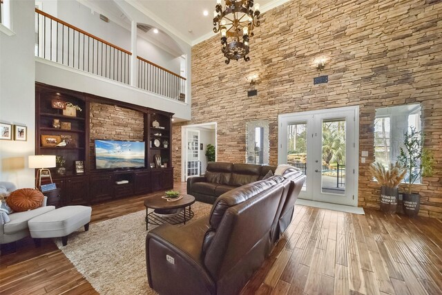 27603 Siandra Creek Ln, Spring, TX 77386 - living area with a towering ceiling, hardwood / wood-style flooring, french doors, ornamental molding, and a chandelier
