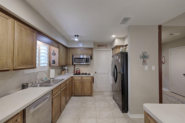900 Manchester Dr, Conroe, TX 77304 - kitchen with stainless steel appliances, a sink, light countertops, and baseboards