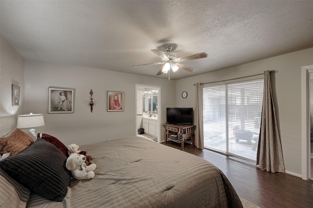 900 Manchester Dr, Conroe, TX 77304 - bedroom featuring dark wood finished floors, access to outside, ceiling fan, connected bathroom, and a textured ceiling