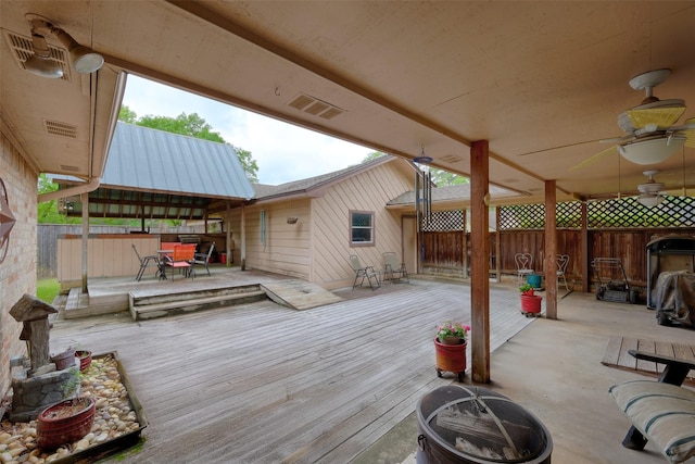 900 Manchester Dr, Conroe, TX 77304 - deck featuring an outdoor fire pit, outdoor dining space, and ceiling fan