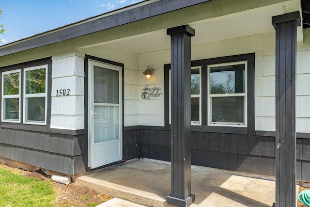 view of exterior entry featuring a porch