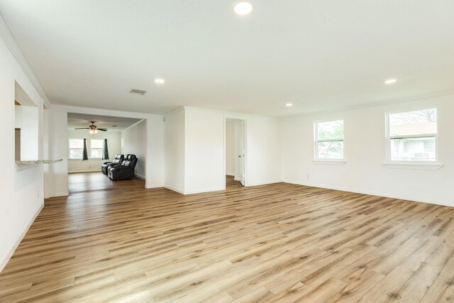 unfurnished living room with light wood finished floors, plenty of natural light, recessed lighting, baseboards, and ceiling fan