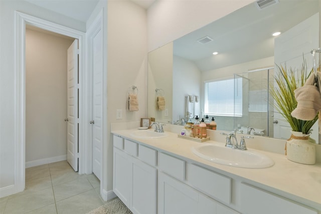 bathroom with a shower stall, tile patterned floors, visible vents, and a sink