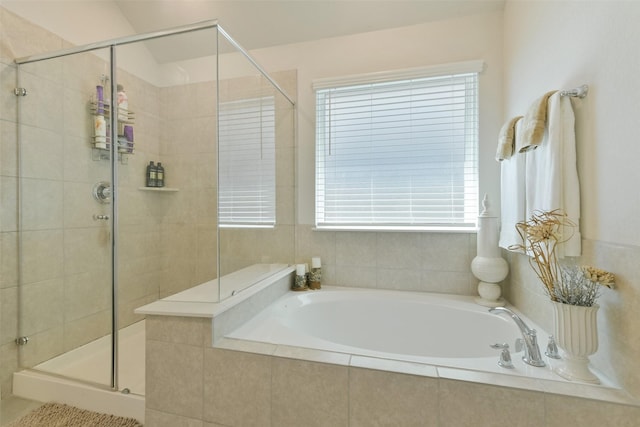 full bathroom with a bath and a shower stall