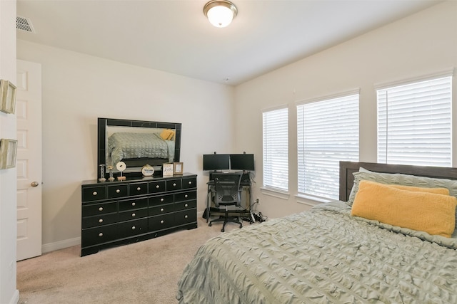 carpeted bedroom featuring baseboards and visible vents