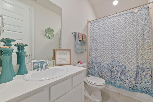 bathroom with toilet, tile patterned flooring, and vanity