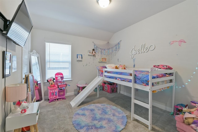 carpeted bedroom featuring baseboards and lofted ceiling