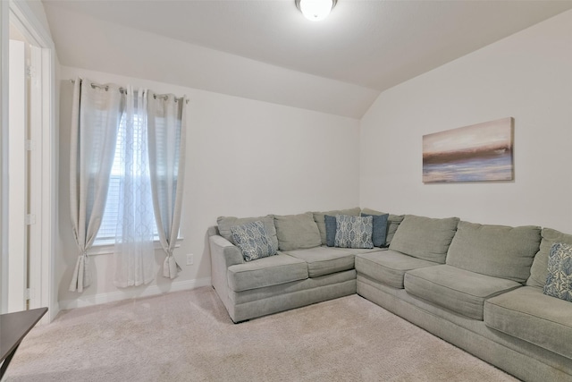 carpeted living room with a wealth of natural light, vaulted ceiling, and baseboards