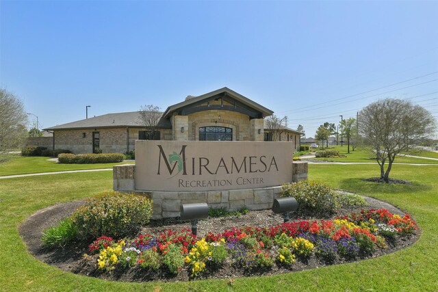 community / neighborhood sign with a lawn