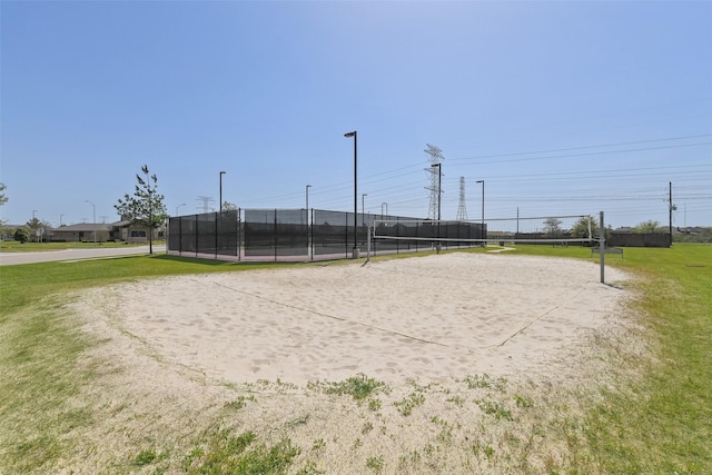view of property's community with volleyball court and fence