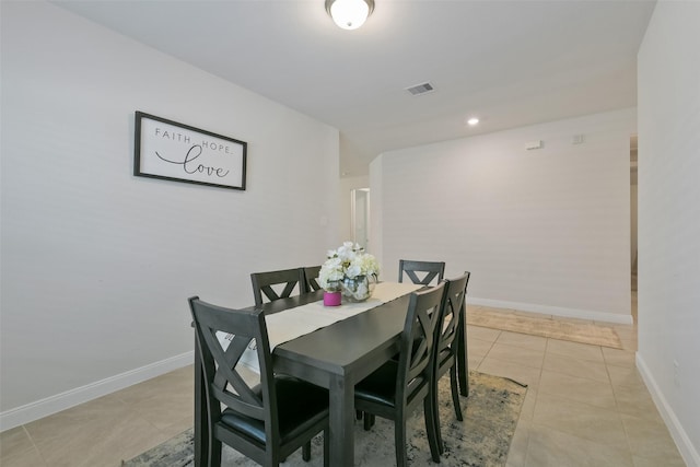 dining area with baseboards, visible vents, and light tile patterned floors