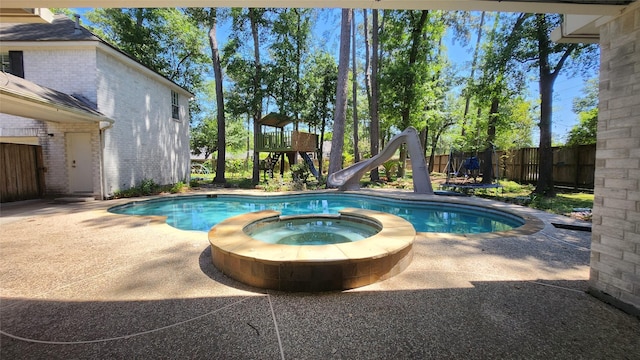 12902 Park Forest Trl, Cypress, TX 77429 - view of pool with a water slide, a pool with connected hot tub, and a patio area
