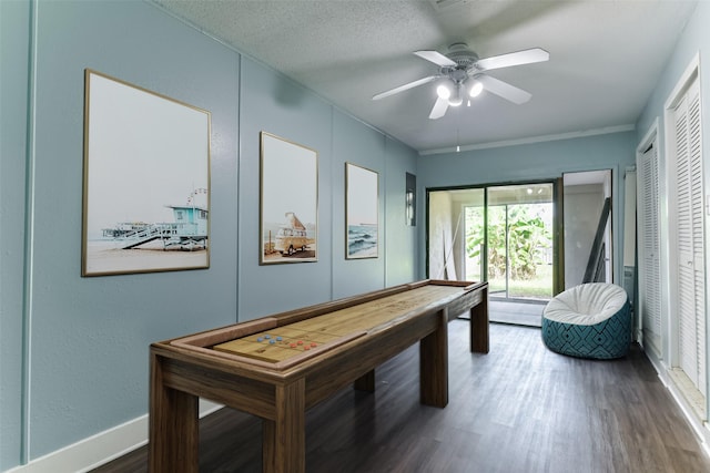 recreation room with a textured ceiling, wood finished floors, baseboards, and a ceiling fan