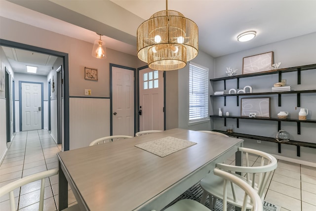 office area with light tile patterned flooring, an inviting chandelier, and attic access