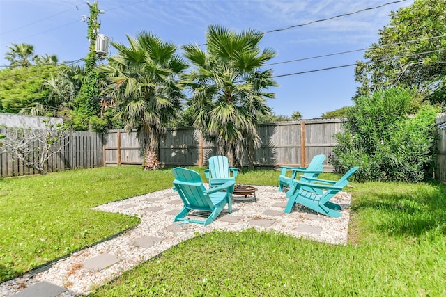 view of yard featuring an outdoor fire pit, a fenced backyard, and a patio
